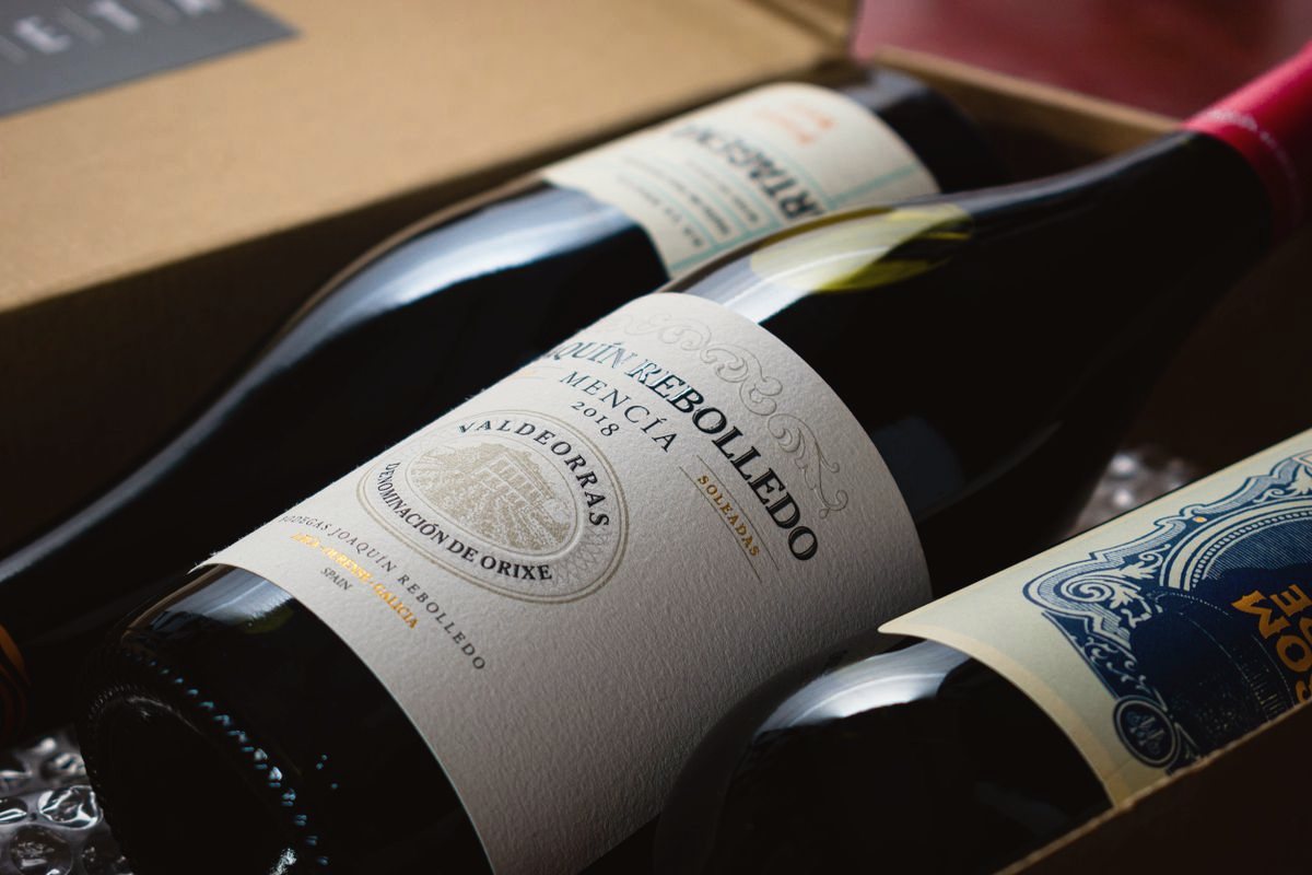 Bottles of red wine packed in a cardboard box, labels facing up